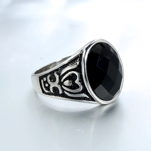 Vintage silver steel ring for men featuring an oval black onyx with ornate relief engraving