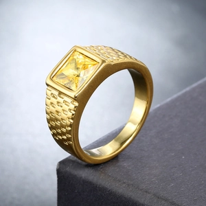 Close-up of men's gold stainless steel ring with rectangular yellow stone and relief texture
