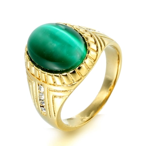 Macro shot of gold stainless steel ring with green cat eye stone and cubic zirconia