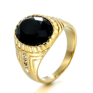 Detail view of a vintage gold ring with large black oval stone and side diamond accents