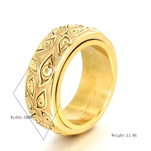 10mm width gold stainless steel spinner ring with embossed eye texture on white background
