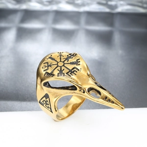 Detail of golden bird skull ring featuring Viking compass and Valknut symbols