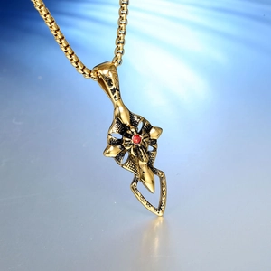 Gothic stainless steel necklace with gold cross wing pendant and red round center stone