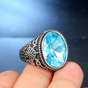 Detailed macro view of retro stainless steel ring with large oval blue gemstone