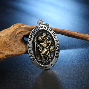 Men's Saint Christopher pendant necklace in silver and gold tone on wood display