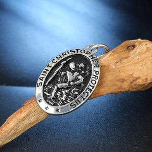 Saint Christopher silver-tone stainless steel pendant on wood with starry background
