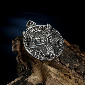 Nordic Viking wolf head amulet pendant necklace in stainless steel on rustic wood