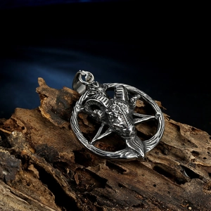 Close-up of vintage punk ram head pendant with pentagram on textured dark wood