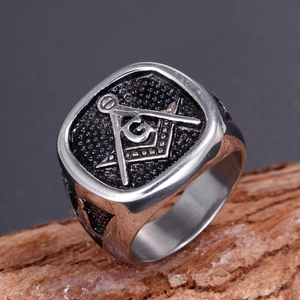 Macro shot of vintage Freemason G symbol and compass detail on stainless steel ring