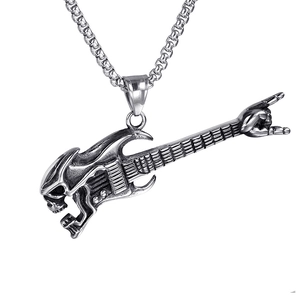 Macro detail of rock guitar skull pendant in vintage silver stainless steel finish