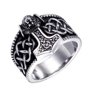 Macro view of vintage stainless steel Mjölnir ring with intricate Celtic knot carvings