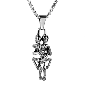 Detailed macro view of vintage silver steel skull pendant featuring intricate erotic carvings