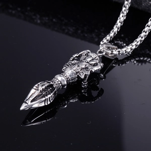 Vintage stainless steel skeleton hand pendant with box chain on reflective background