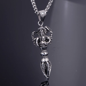 Macro detail of antique silver Ganesha Vajra pendant with religious vintage style textures