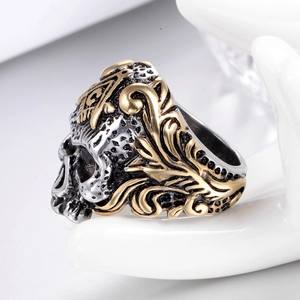 Detail of punk gothic skull ring with Masonic symbol and golden filigree accents