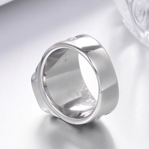 Detailed close-up showing the smooth inner band and carved texture of the stainless steel ring