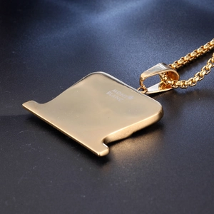 Macro shot of gold stainless steel necklace pendant with star logo and branding detail
