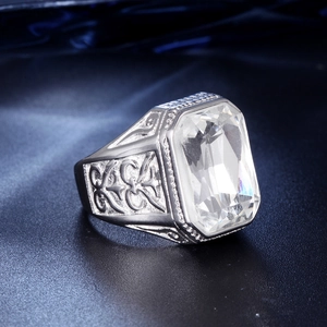 Macro detail of silver stainless steel ring featuring a large rectangular gemstone and carvings