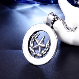 Detail of vintage hip hop star pendant on hand stand with square pearl chain necklace