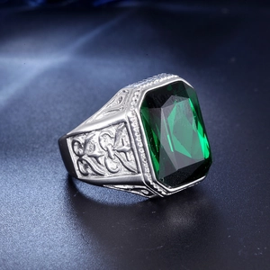 Vintage stainless steel ring with emerald-cut green gemstone and engraved floral band