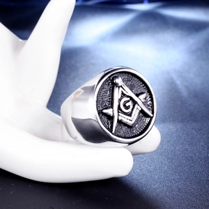 Silver stainless steel Freemason ring featuring compass and square symbol on a display hand