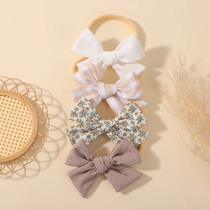 Set of 4 elastic nylon baby headbands with assorted cotton bow patterns for infants