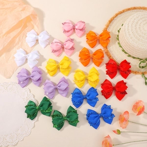 Set of 16 colorful glitter bow hair clips for girls in various vibrant bright colors