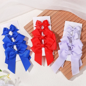 Lot de quatre barrettes à nœuds en ruban gros-grain bleu, rouge et violet pour filles