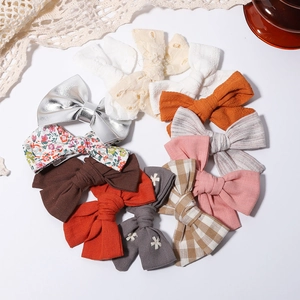 Set of 11 handmade floral and solid bow hair clips for girls in various fabric styles