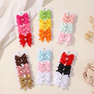 Set of 6 colorful satin bow hair clips for kids on display cards in various vibrant colors