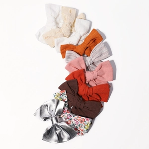 Set of colorful handmade bow hair clips with diverse textures and floral patterns