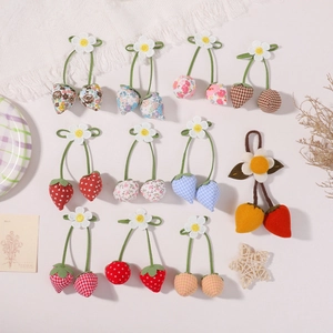 Handmade fabric strawberry pendants with floral, polka dot, and plaid patterns