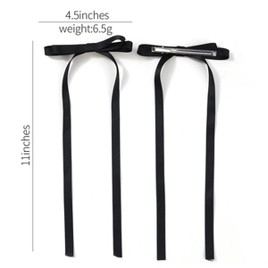 Solid black ribbon bow hair clip with long streamers and silver metal fastener