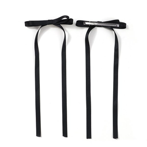 Pair of black satin bow hair clips with long ribbons and metal duckbill clips