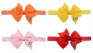 Detailansicht großer Schleifen-Stirnbänder für Babys in Orange, Gelb, Rosa und Rotfarben