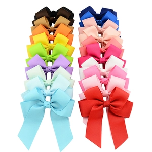 Detailed macro view showing diverse ribbon textures and colors of handmade hair bows
