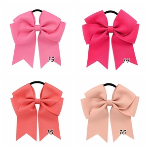 Detail view of 4.5 inch ribbed ribbon bow hair clips with elastic bands in four soft colors