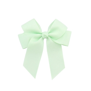Mint green handmade grosgrain ribbon hair bow with long streamers on white background