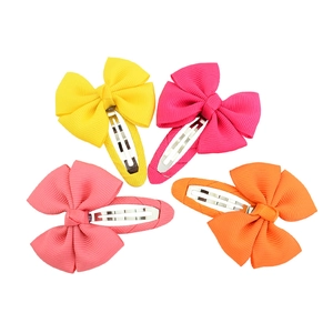 Set of 4 colorful grosgrain ribbon bow hair clips in pink, yellow, and orange for girls