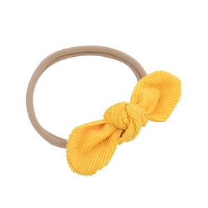 Elastic nylon baby headband with yellow corduroy bow tie design on white background
