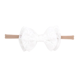 Close-up of white lace bow headband with a soft elastic nylon band for newborn babies