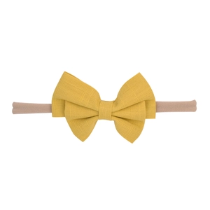 Detail of mustard yellow cotton bow headband with high-elastic seamless band for babies