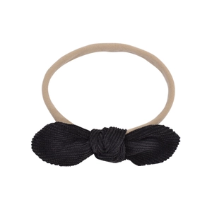 Detail of high-elasticity nylon baby headband featuring a black corduroy bow texture