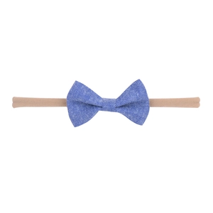 Close-up of baby headband with dark blue chambray bow on elastic nylon band