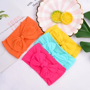 Set of four colorful baby nylon headbands with large soft folded bows in vibrant spring colors
