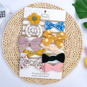 Detailed set of 10 soft nylon baby headbands with assorted floral and velvet bows