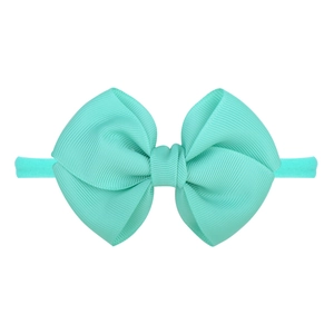Bandeau bébé en nylon vert menthe avec un grand nœud décoratif en ruban gros-grain