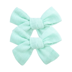 Paire de barrettes à nœuds en lin vert menthe pour filles avec texture unicolore
