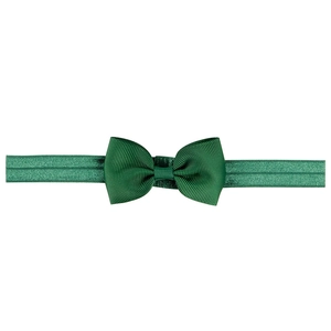 Close-up of dark green ribbed grosgrain bow on elastic baby headband accessory
