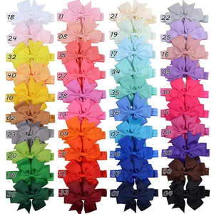 Detail view of 40 colors of grosgrain ribbon bows on soft elastic headbands for infants